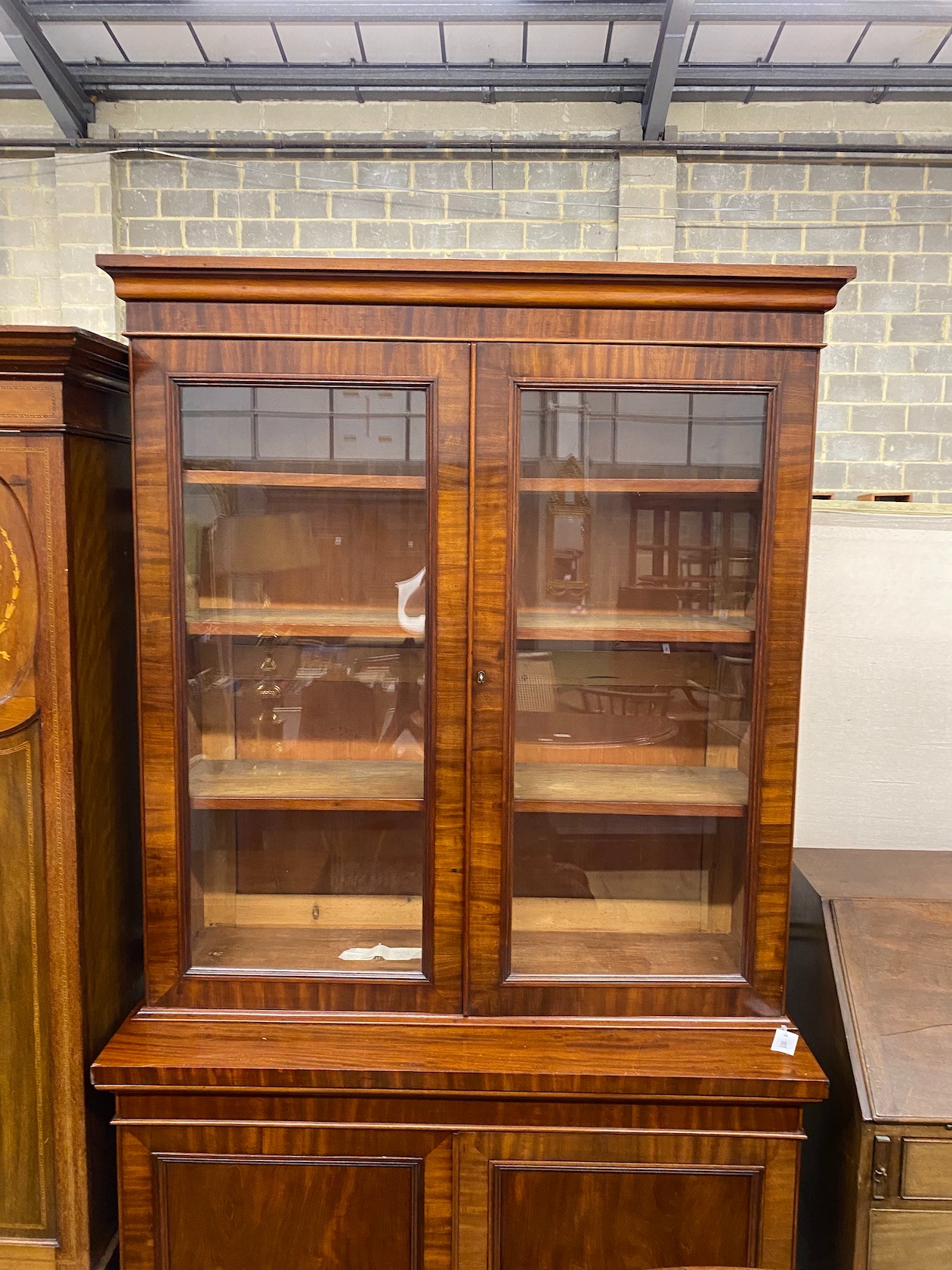 A Victorian mahogany bookcase cupboard width 118cm, depth 49cm, height 217cm.